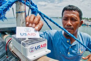 A man using a traceability system from USAID