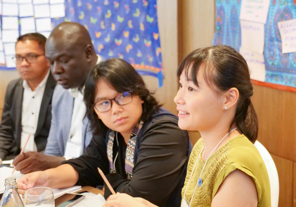 4 Participants at Salt's 2019 PartnerLab sit at a table.