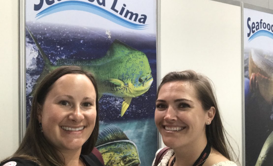 FishWise Staff Sarah Caldwell and Lindsay Jennings in front of a Seafood Lima sign