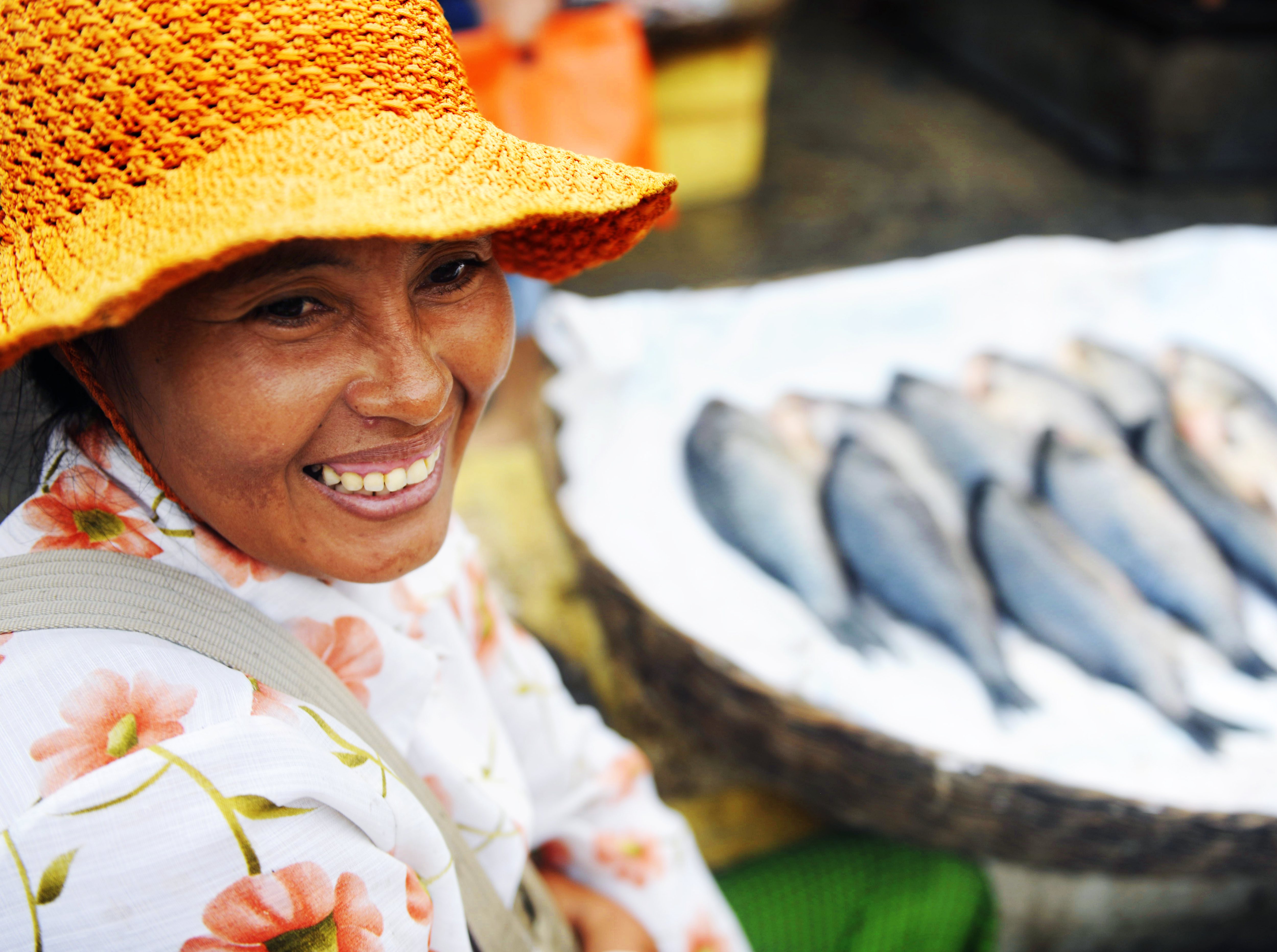 lady in front of fish at market